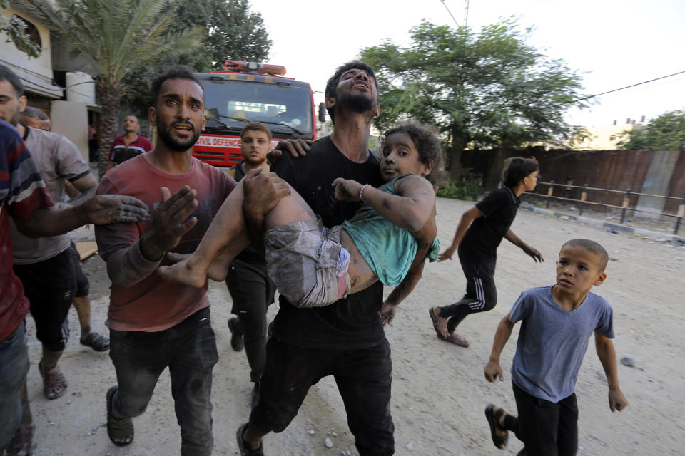 Palestinians carry a wounded girl after being rescued from under the rubble of buildings that were destroyed by Israeli airstrikes in Jabaliya refugee camp, northern Gaza Strip, Wednesday, Nov. 1, 2023. (AP Photo/Abed Khaled)