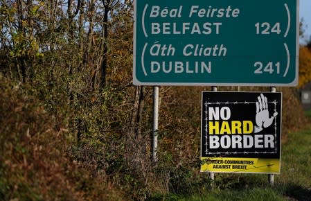A 'No hard Border' poster is seen below a road sign on the Irish side of the border between Ireland and Northern Ireland near Bridgend