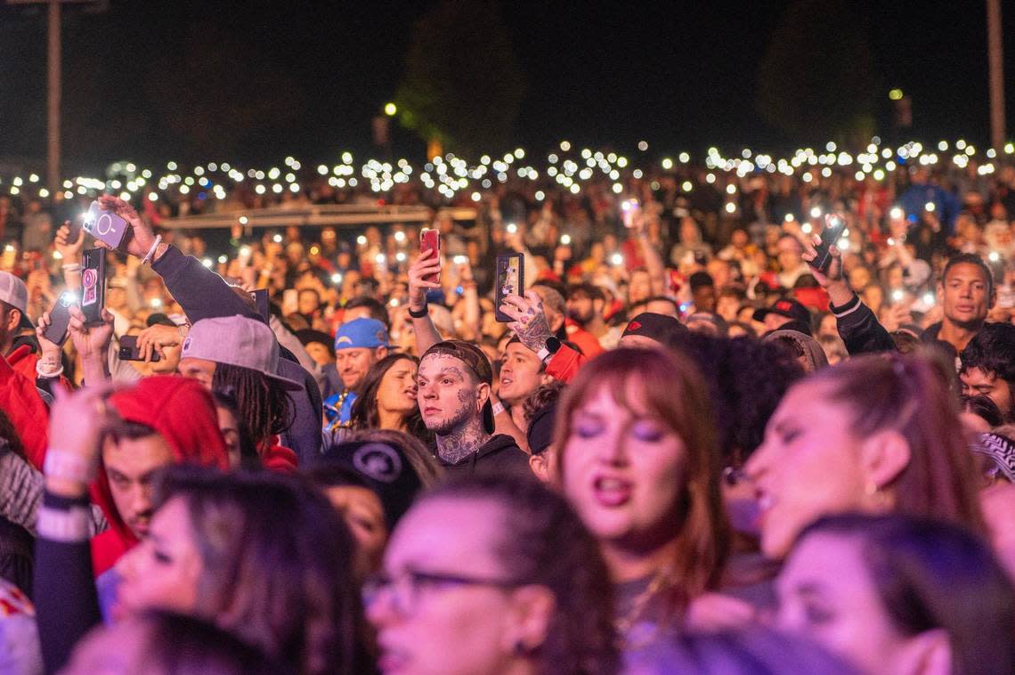 Fans hold up their cellphone lights while Machine Gun Kelly performs at Kelce Jam. Emily Curiel/ecuriel@kcstar.com
