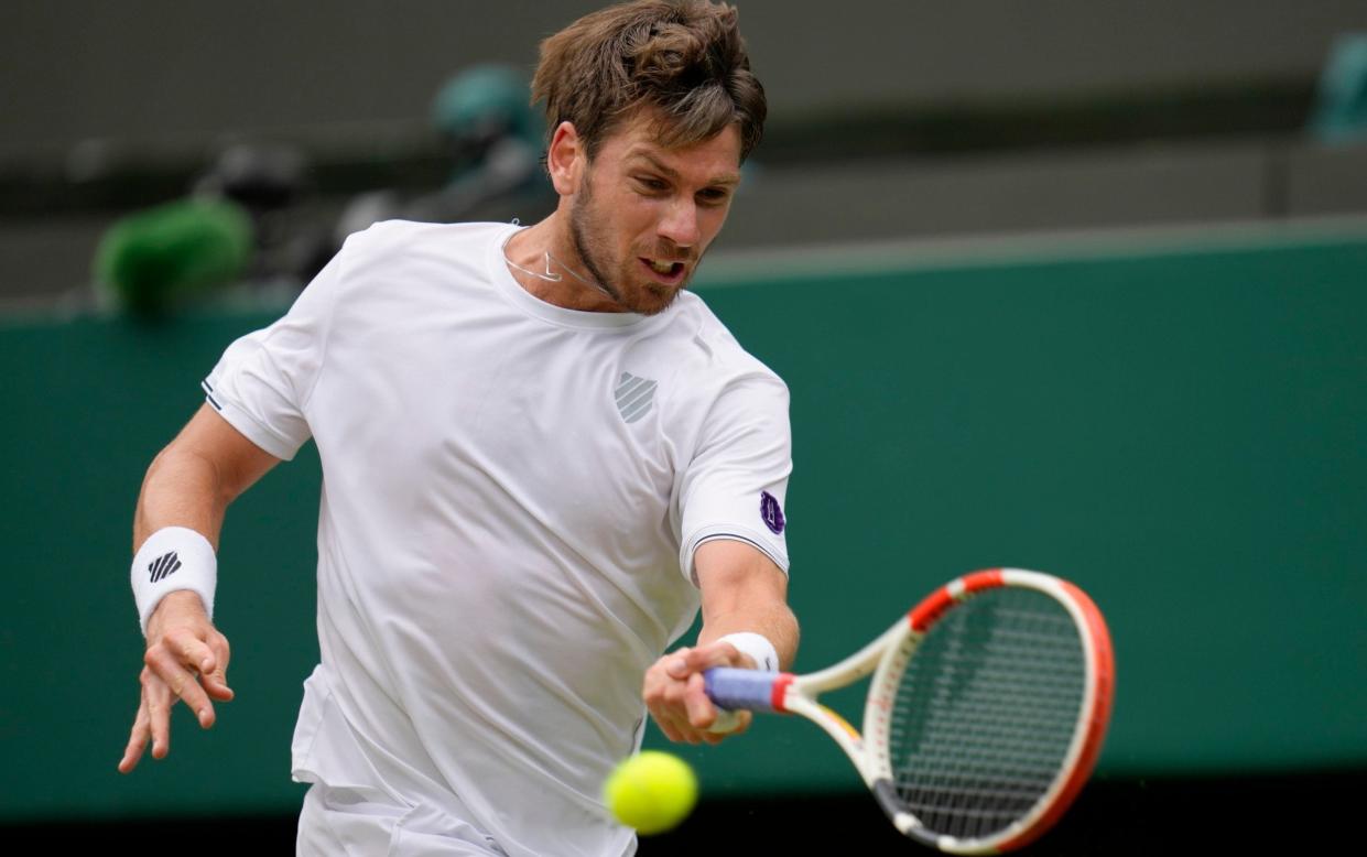 Britain's Cameron Norrie plays a return to Belgium's David Goffin in a men's singles quarterfinal match at the Wimbledon tennis championships in London, Tuesday July 5, - AP Photo/Kirsty Wigglesworth