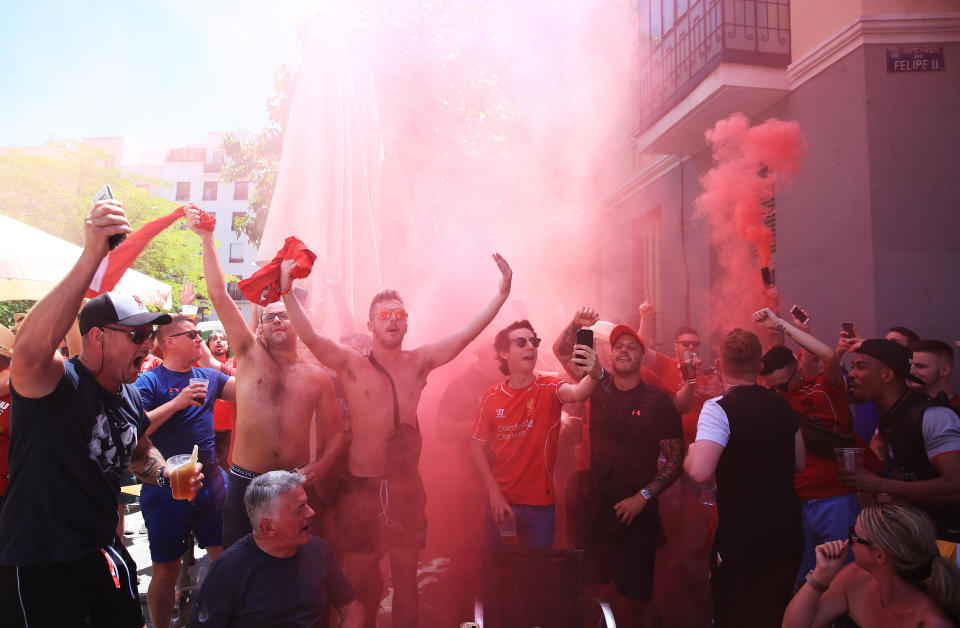 Liverpool fans set off a smoke flare Plaza de Felipe II in Madrid, Spain.