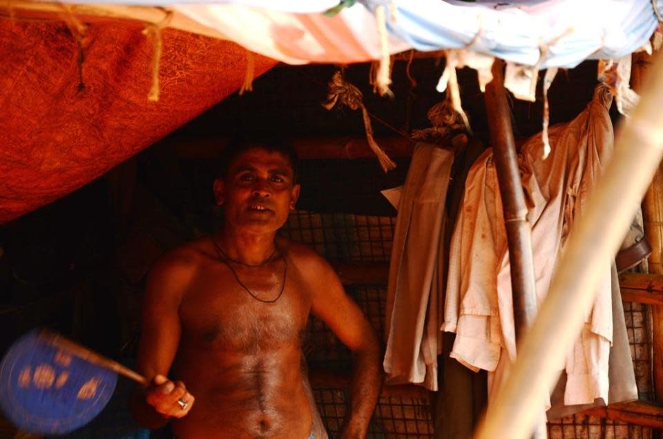 A man cools off with a hand fan in the sweltering heat.