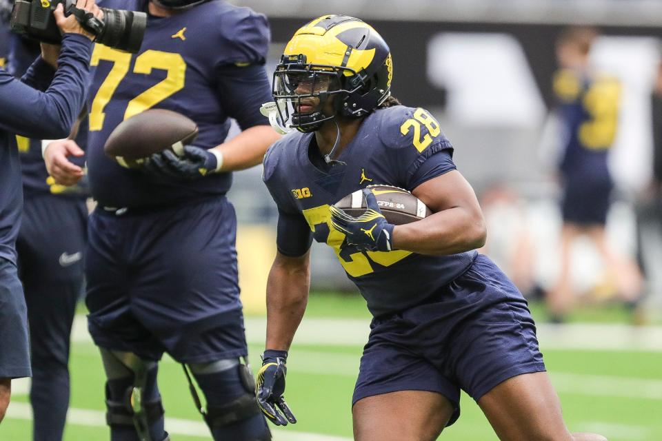 Michigan running back Benjamin Hall (28) runs a drill during open practice at NRG Stadium in Houston, Texas on Saturday, Jan. 6, 2024.