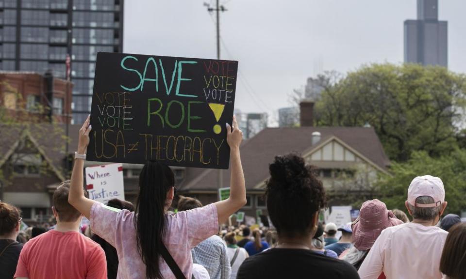 person holds sign that says ‘save roe - USA does not equal theocracy’