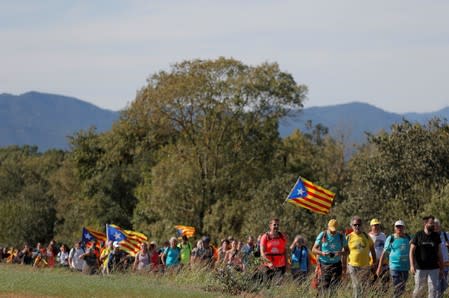 Separatist demonstrators march during a protest after a verdict in a trial over a banned Catalonia's independence referendum near Sils