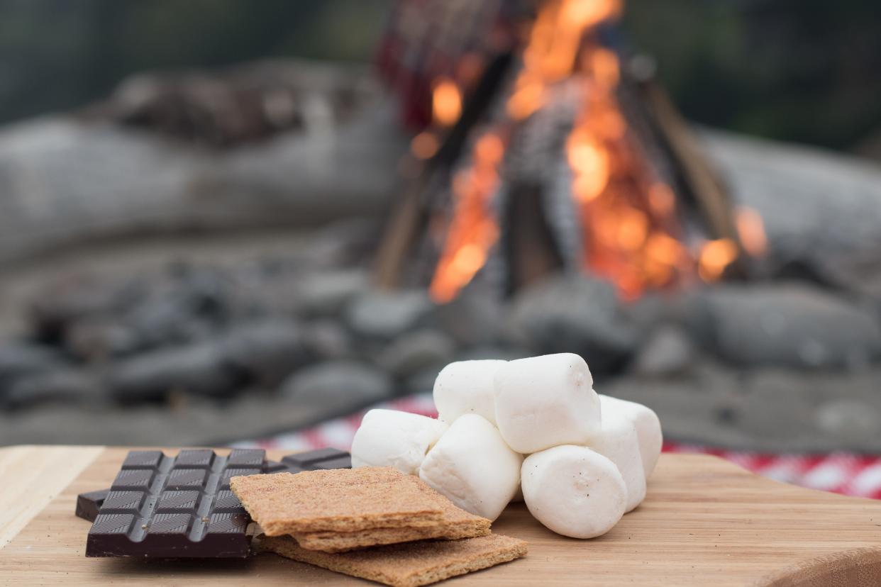 Graham crackers play a key role in Smores made over a camp fire.
