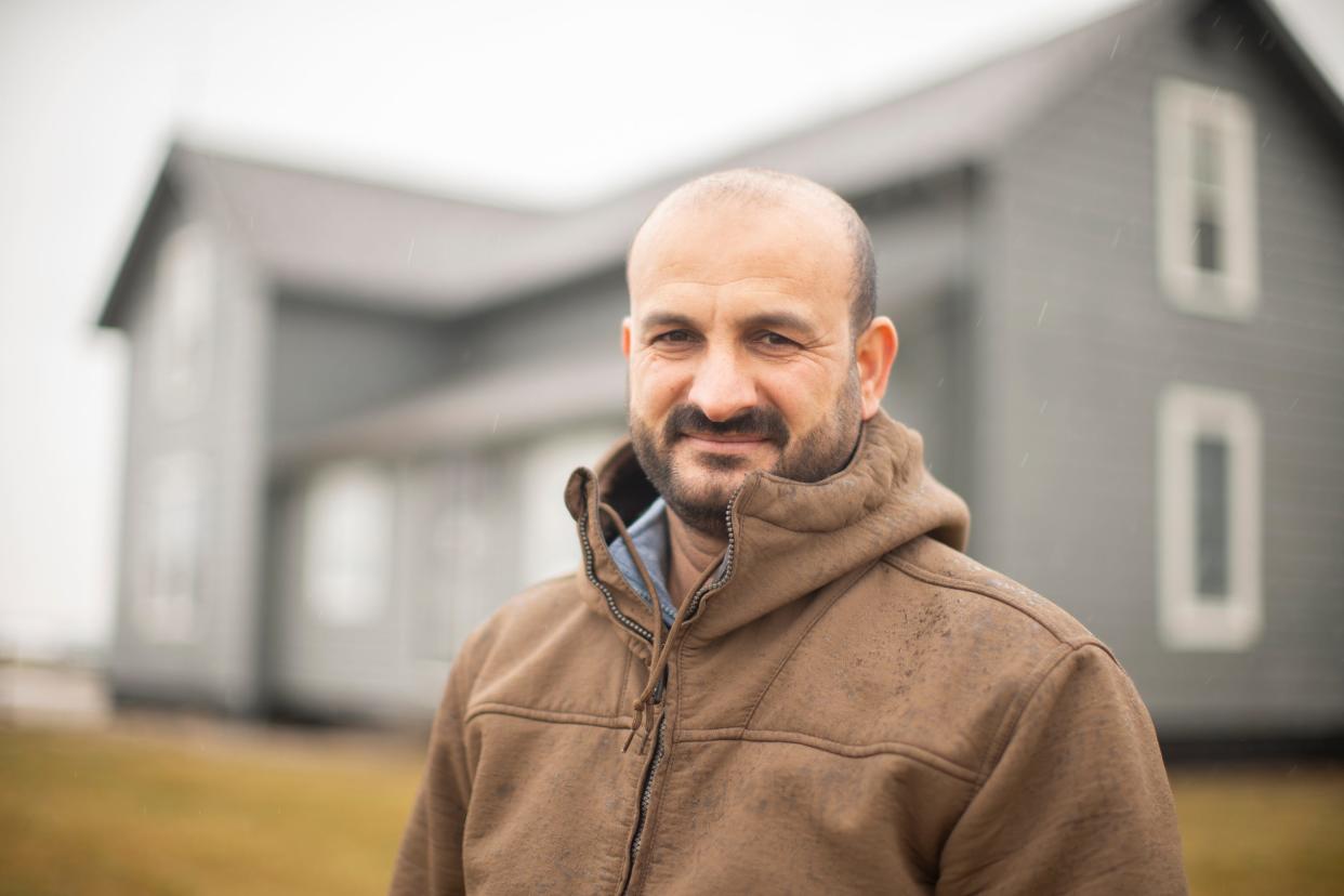 Amjad Ashnawi, an Iraqi American former refugee, stands Wednesday outside a Marysville farm he owns with his wife and children. Homeownership u0022means the hard work he's put in since he came here. ... He worked really, really hard,u0022 said Ashnawi's wife, Shwrsh Malih.