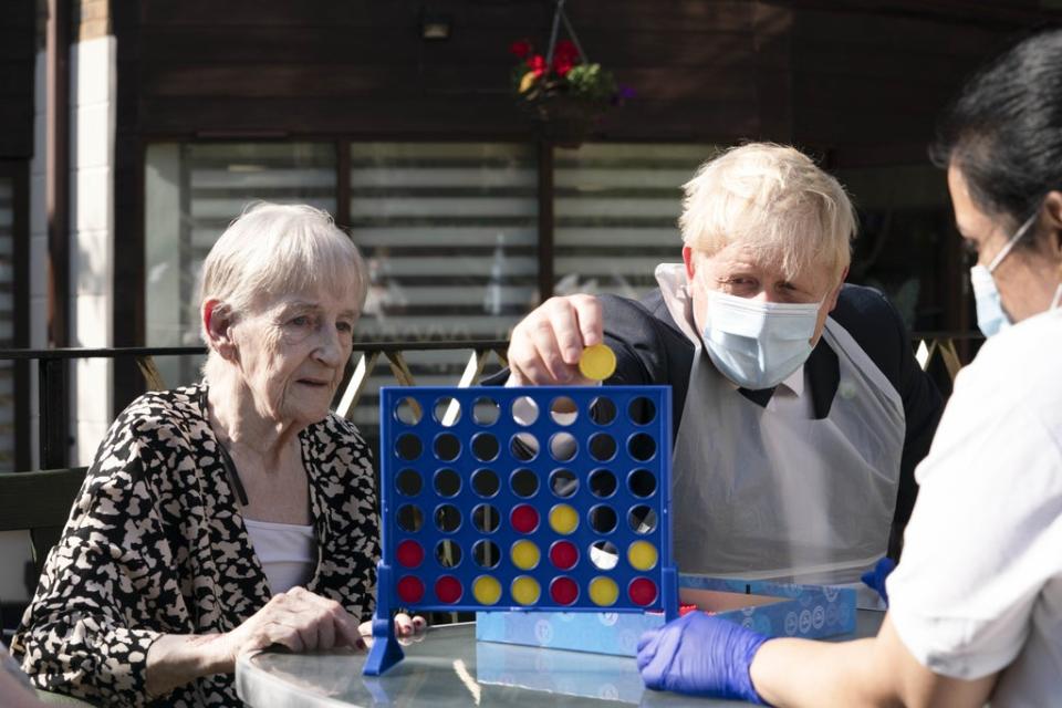 Prime Minister Boris Johnson plays Connect 4 with resident Janet (left) and carer Lakshmi during a visit to Westport Care Home in Stepney Green, east London (Paul Edwards/The Sun/PA) (PA Wire)