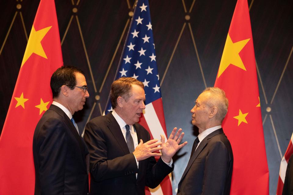 United States Trade Representative Robert Lighthizer (C) gestures as he chats with Chinese Vice Premier Liu He (R) as US Treasury Secretary Steven Mnuchin (L) looks on after posing for a "family photo" at the Xijiao Conference Centre in Shanghai on July 31, 2019. - Chinese and US negotiators held talks in Shanghai on July 31 in a bid to bring an end to a year-long trade war, with the meeting overshadowed by a Twitter tirade from President Donald Trump. (Photo by Ng Han Guan / POOL / AFP)        (Photo credit should read NG HAN GUAN/AFP via Getty Images)