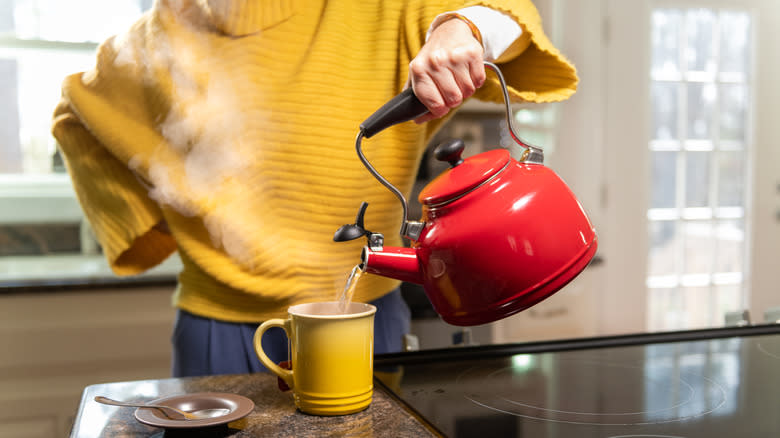 woman pouring from a kettle