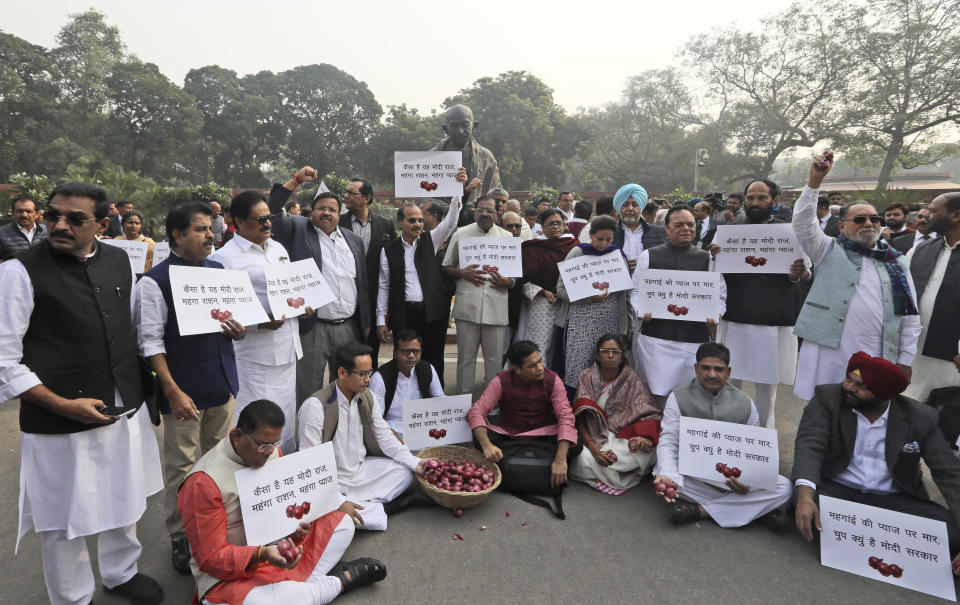 Lawmakers from the Congress party hold placards and participate in a protest against the rise in onion prices, at the Indian Parliament House in New Delhi, India, Thursday, Dec. 5, 2019. India’s economic growth was 4.5% in July-September. Many economists believe the economy was weakened by the currency demonetization in 2016 and a hasty rollout of a goods and services tax. (AP Photo/Manish Swarup)