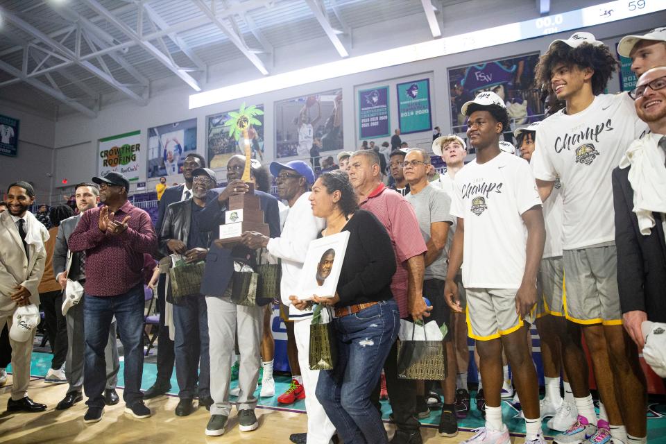 Members and family of the of the 1973 Immokalee High School basketball team were on hand to present the championship trophy to Montverde after the City of Palms tournament at Suncoast Credit Union Arena on Saturday, Dec. 23, 2023. Immokalee was the first winning team of the tournament.