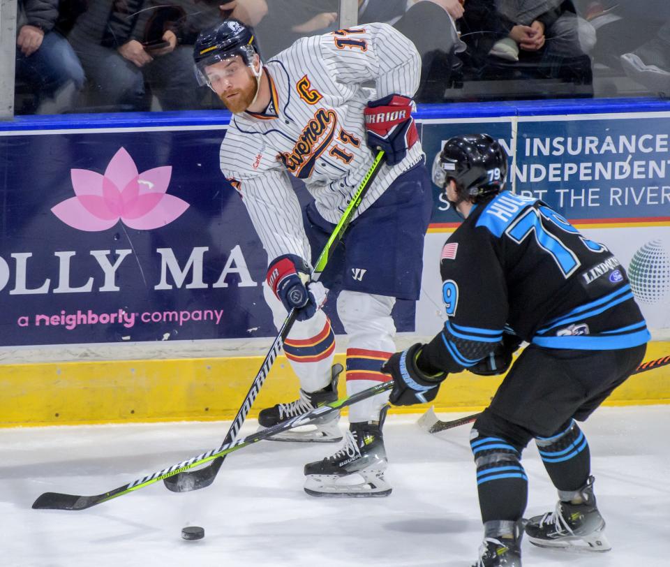 Peoria's Alec Hagaman passes the puck past Quad City's Hayden Hulton in the first period of their SPHL hockey game Saturday, April 6, 2024 at the Peoria Civic Center.