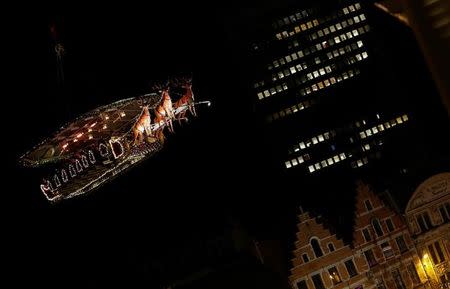 Guests enjoy dinner at the table "Santa in the sky", lifted by a crane and decorated to match the appearance of a "Santa Sleigh" as part as the Christmas festivities, in Brussels, Belgium, November 25, 2016. Picture taken November 25, 2016. REUTERS/Yves Herman