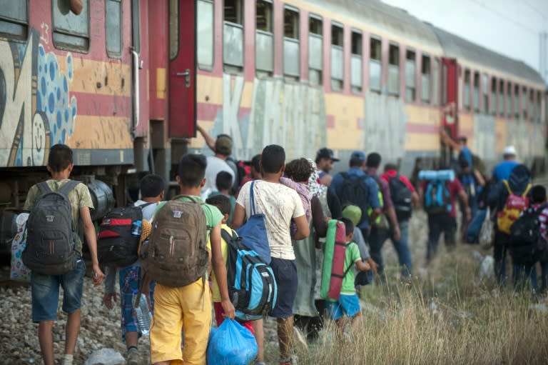 Migrants board a train after crossing the Macedonian-Greek border near Gevgelija on September 6, 2015