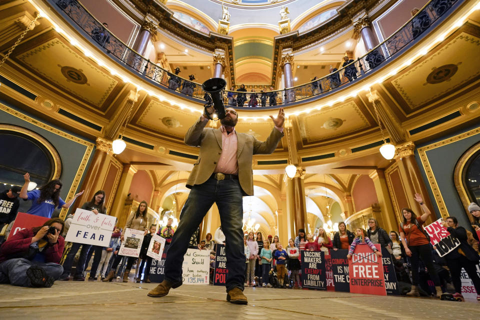 Steve Rowland speaks as protestors gather in the Iowa Capitol rotunda to voice their opposition to mask mandates, Monday, Jan. 11, 2021, at the Statehouse in Des Moines, Iowa. (AP Photo/Charlie Neibergall)