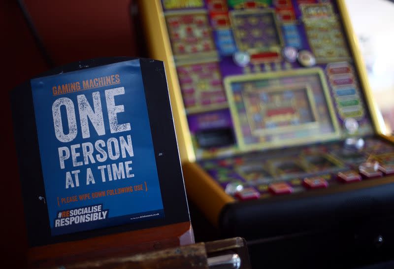 A sign is seen next to a gaming machine in the Chandos Arms pub ahead of pubs reopening following the coronavirus disease (COVID-19) outbreak, in London