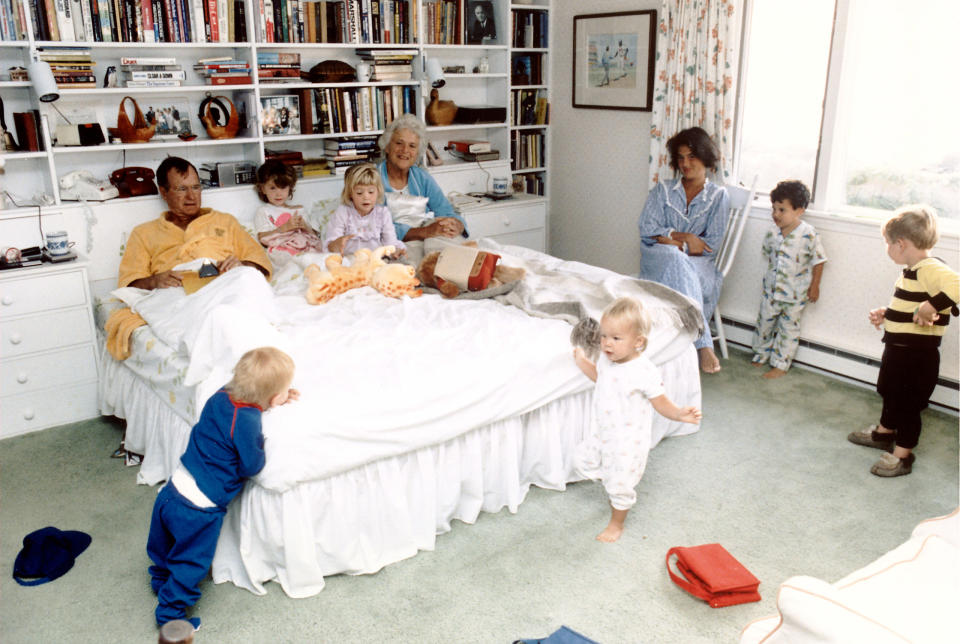 President George H.W. and Barbara Bush with their grandchildren (L-R) Pierce, twins Barbara and Jenna (in bed), Marshall, Jeb. Jr. and Sam LeBlond in the bedroom of their summer home at Walker's Point in Kennebunkport, Maine, in 1987.