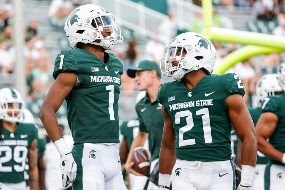 Michigan State safety Jaden Mangham (1) and defensive back Dillon Tatum (21) warm up before the game against Western Michigan at Spartan Stadium in East Lansing on Friday, Sept. 2, 2022.