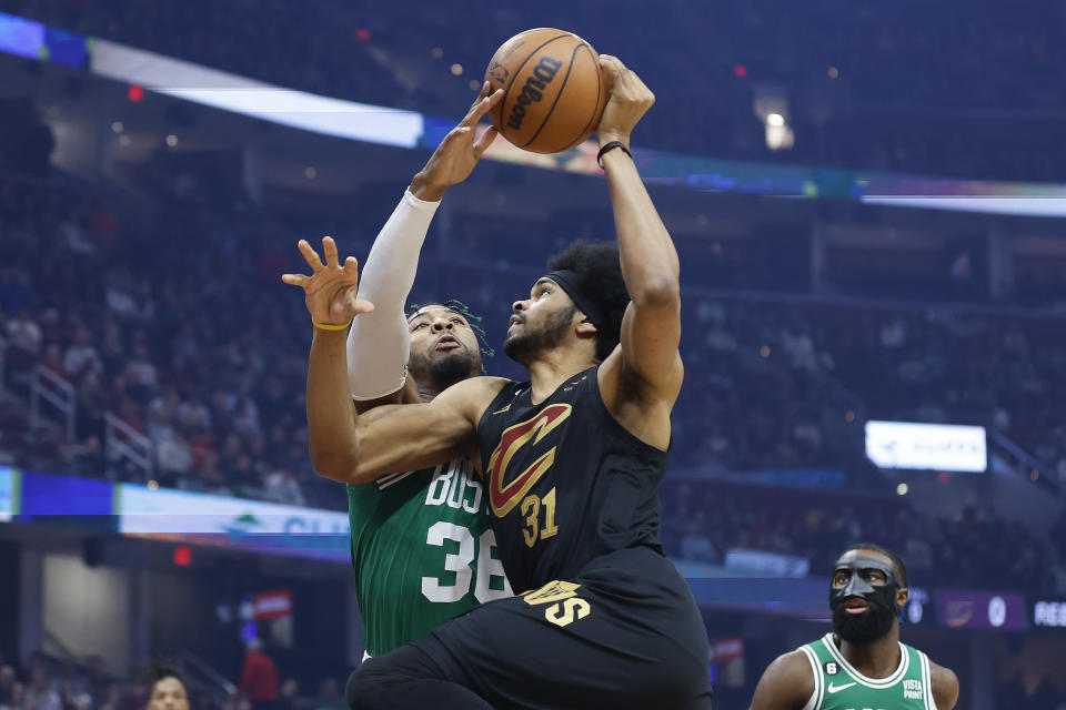 Boston Celtics guard Marcus Smart blocks a shot by Cleveland Cavaliers center Jarrett Allen (31) during the first half of an NBA basketball game, Monday, March 6, 2023, in Cleveland. (AP Photo/Ron Schwane)