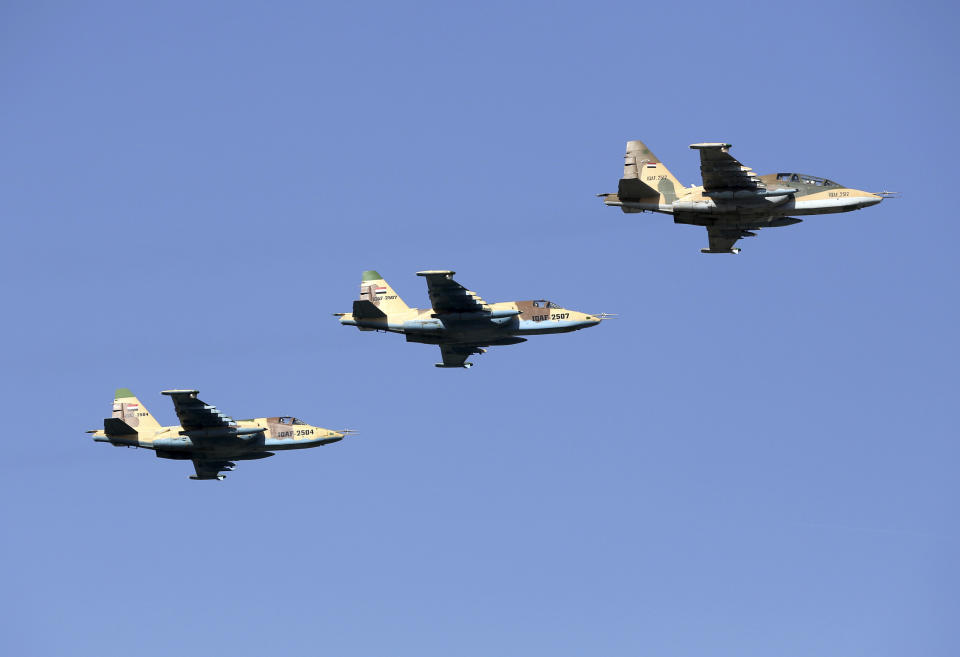 FILE - In this July 14, 2016, file, photo, Iraqi Air Force jets take part in a military parade in Baghdad, Iraq. Syria’s state news agency said Sunday, Dec. 30, 2018 that President Bashar Assad has authorized Iraqi forces to attack the Islamic State group inside Syria without waiting for permission from authorities in Damascus. (AP Photo/Hadi Mizban, File)