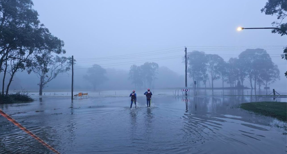 SES volunteers standing in floodwaters, as the the BoM declares Australia is on La Niña watch. 