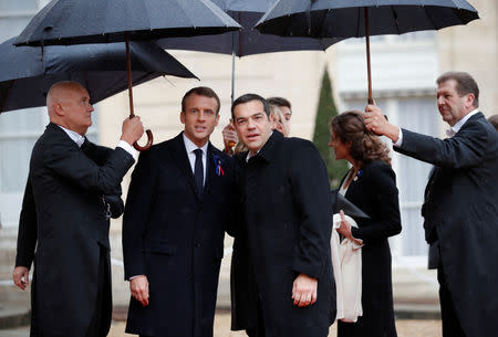 French President Emmanuel Macron poses with Greek Prime Minister Alexis Tsipras at the Elysee Palace as part of the commemoration ceremony for Armistice Day, 100 years after the end of the First World War, in Paris, France, November 11, 2018. REUTERS/Philippe Wojazer