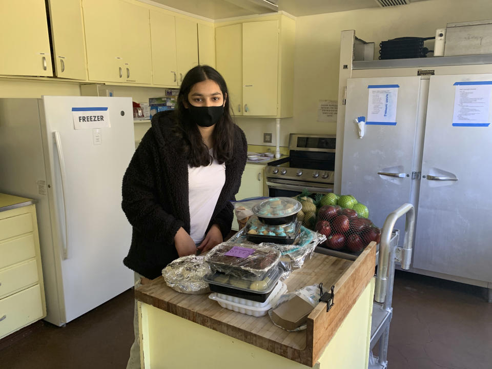 Vedika Jawa poses with freshly baked desserts inside South Hayward Parish in Fremont, Calif., on Feb. 1, 2021. Jawa, a high school junior, distributes sweets to 15 shelters through a non-profit she started when she was 13. (Rachna Jawa via AP)