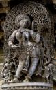 Darpana Sundari (lady with mirror) is one of the main attractions in the temple. The intricate carvings include the mirror frame, the tendrils around the lady, and her jewelry. A maid on her right is feeding grapes to a pet monkey.