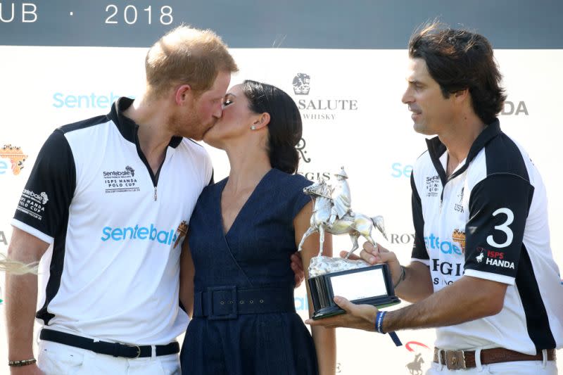 Prince Harry and Meghan Markle shared a smooch during the Sentebale Polo match. [Photo: Getty]