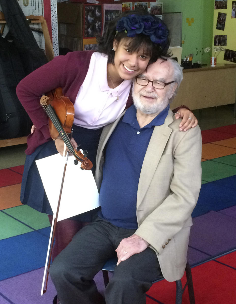 Brianna Perez, a Bronx schoolgirl, hugs Joseph Feingold at the Bronx Global Learning Institute for Girls in the Bronx, New York, on June 15, 2015. Perez and Feingold were featured in an Oscar-nominated 2016 documentary, "Joe's Violin," about Feingold's gift of a violin during an instrument drive in New York, which brought him some fame late in life. Perez was the first recipient of the violin. Joseph Feingold died at age 97 of complications from the new coronavirus, four weeks after his brother Alexander, 95, died of pneumonia at the same New York hospital. The brothers were Polish-born Holocaust survivors who had a difficult relationship shaped by the trauma of the war and the loss of their beloved mother and younger brother in Treblinka. (Raphaela Neihausen via AP)