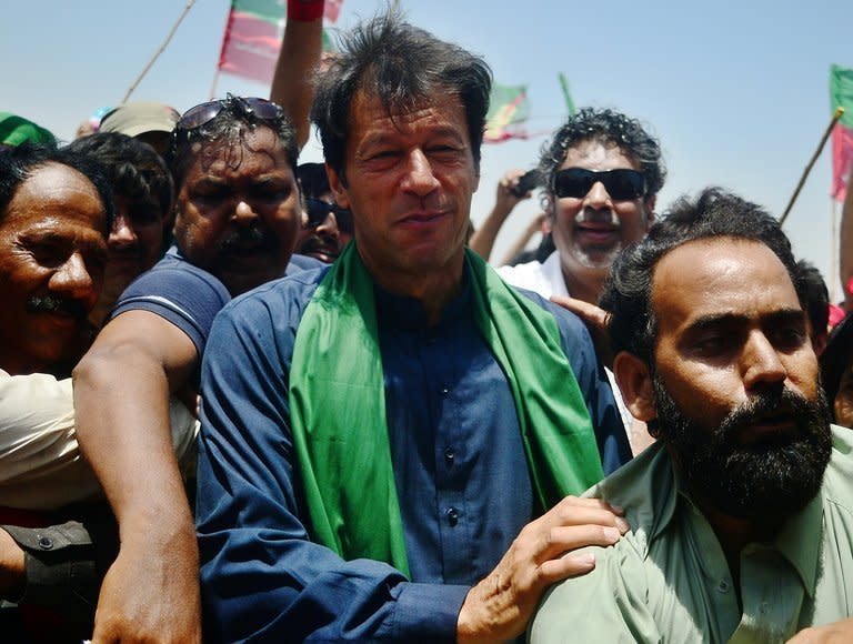 Pakistani cricket legend turned politician Imran Khan is surrounded by his supporters during a campaign rally in Karachi on May 7, 2013. Khan, who won only one seat in 2002 and boycotted polls in 2008, has led an electric campaign, galvanising the middle class and young people in what he has called a "tsunami" of support that will propel him into office