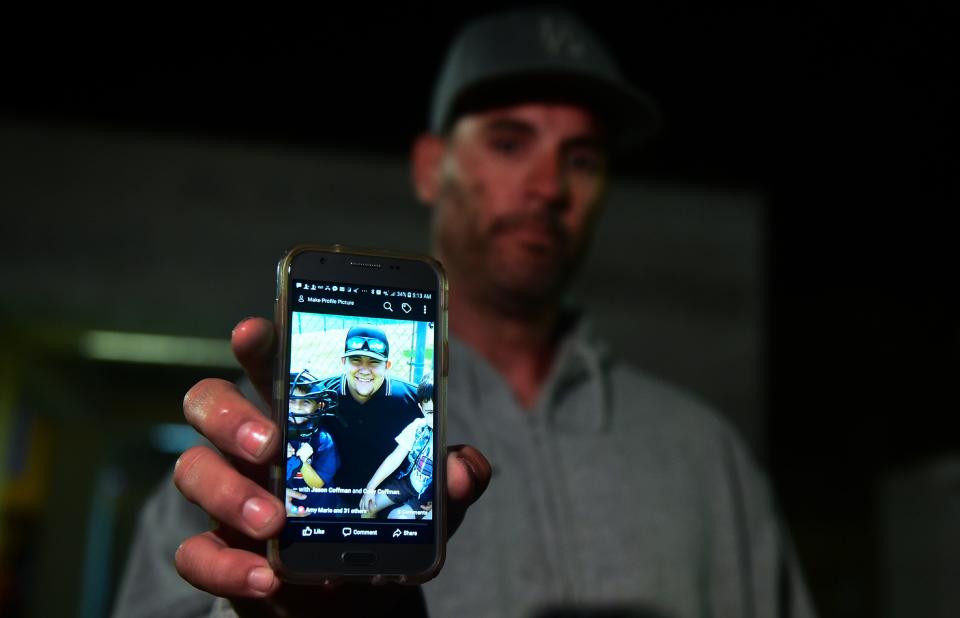 Jason Coffman displays a photo of his son Cody outside the Thousands Oaks Teen Center, where he came hoping to find his son who was at the Borderline Bar &amp; Grill.