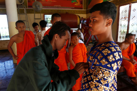 A dancer gets ready before a performance of masked theatre known as Lakhon Khol which was recently listed by UNESCO, the United Nations' cultural agency, as an intangible cultural heritage, along with neighbouring Thailand's version of the dance, known as Khon at the Wat Svay Andet buddhist temple in Kandal province, Cambodia, December 16, 2018. REUTERS/Samrang Pring