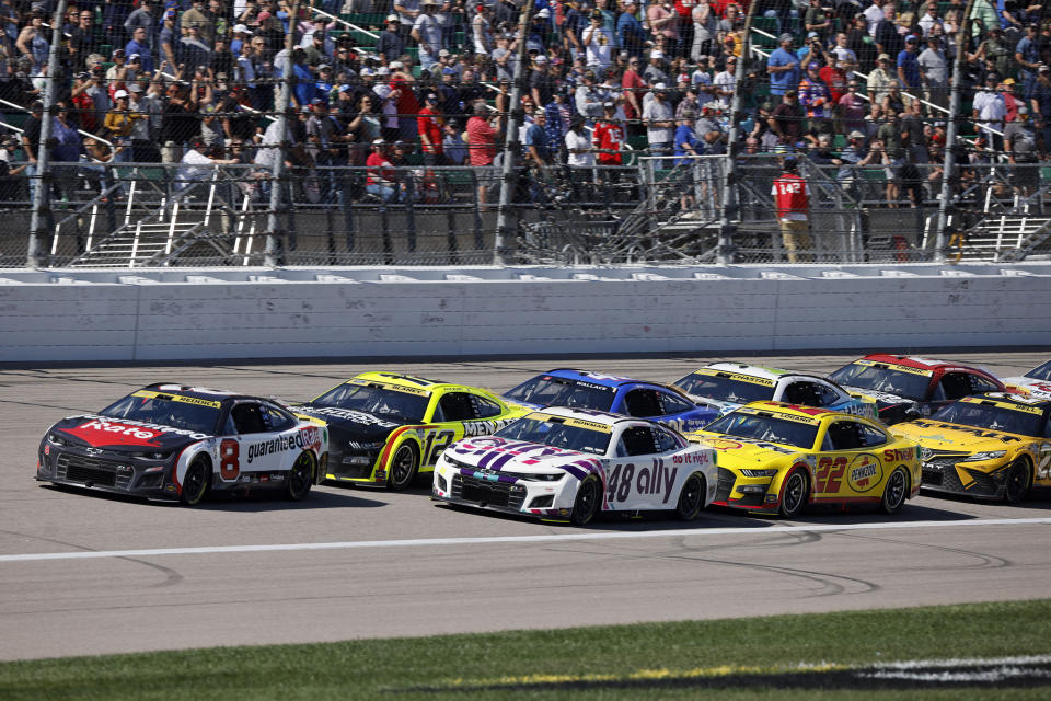 Racers head down the front straightaway during a restart at a NASCAR Cup Series auto race at Kansas Speedway in Kansas City, Kan., Sunday, Sept. 11, 2022. (AP Photo/Colin E. Braley)