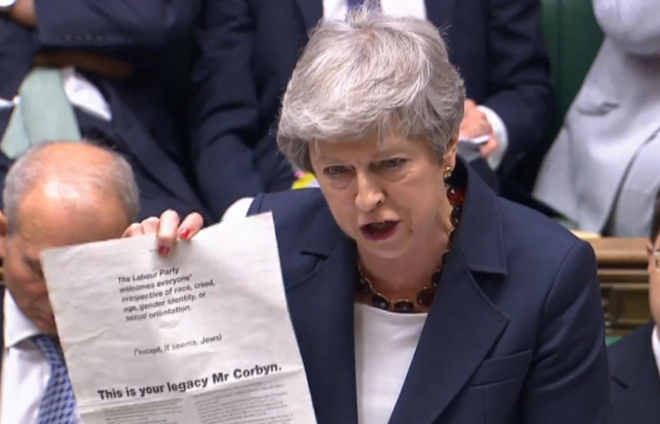 Prime Minister Theresa May holding up an advert taken from today's Guardian, where more than 60 Labour peers accuse party leader Jeremy Corbyn of "failing the test of leadership", during Prime Minister's Questions in the House of Commons, London. PRESS ASSOCIATION Photo. Picture date: Wednesday July 17, 2019. See PA story POLITICS PMQs. Photo credit should read: House of Commons/PA Wire
