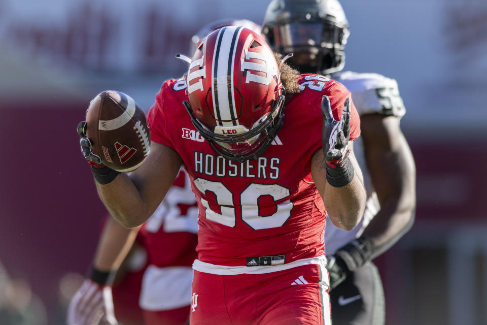 Indiana running back Josh Henderson (26) reacts after running for a first down during the second half of an NCAA college football game against Michigan State, Saturday, Nov. 18, 2023, in Bloomington, Ind. (AP Photo/Doug McSchooler)