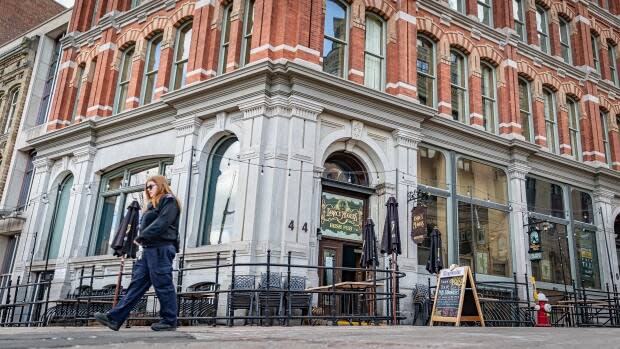 A person walks by a downtown Ottawa restaurant with a closed patio, due to COVID-19 restrictions, on April 14, 2021. (Brian Morris/CBC - image credit)