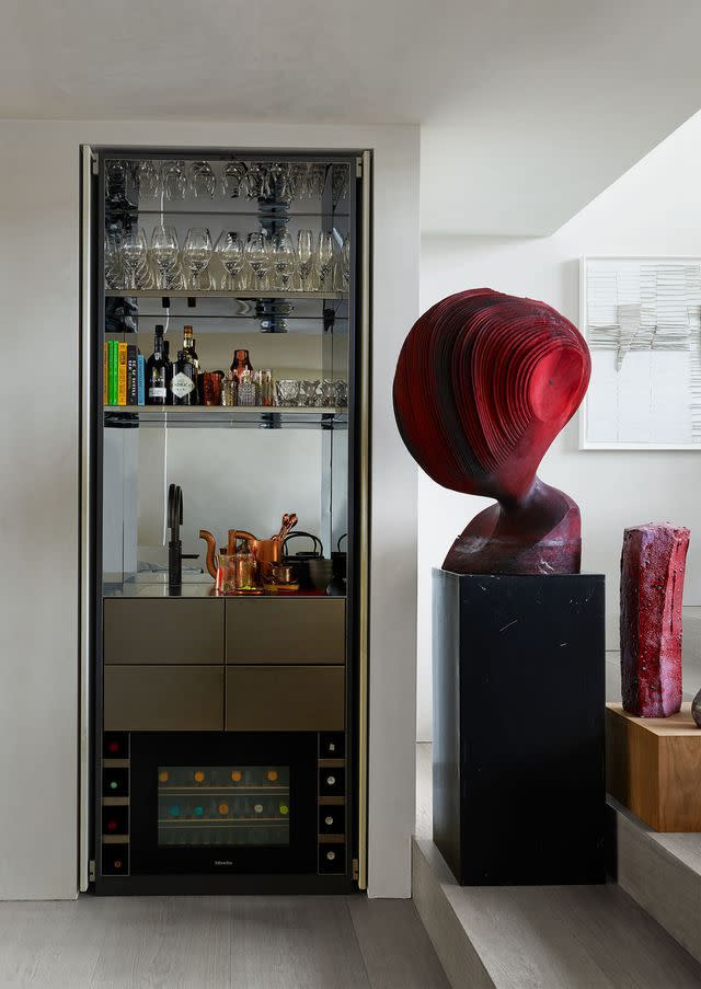 a room with a shelf and a bookcase with objects on it