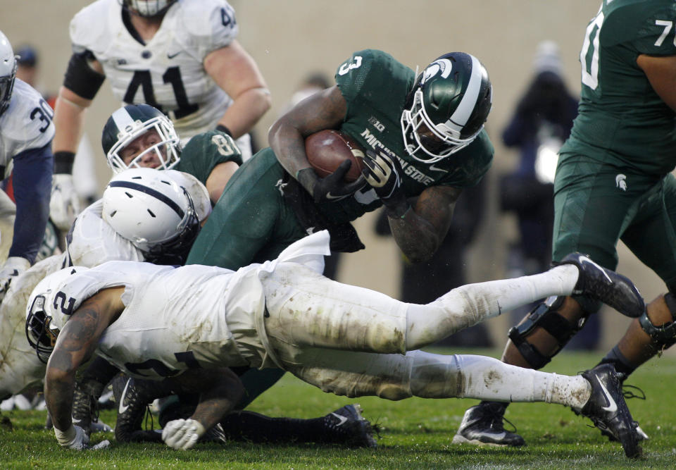 Michigan State running back LJ Scott (3) dives over Penn State’s Marcus Allen (2) for a touchdown during the second half of an NCAA college football game, Saturday, Nov. 4, 2017, in East Lansing, Mich. (AP Photo/Al Goldis)