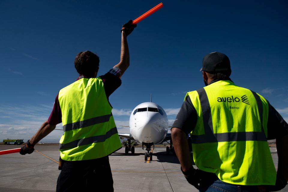 Northern Colorado Regional Airport ground crews guide an Avelo Airlines' Boeing 737-700 for takeoff at the Northern Colorado Regional Airport on Oct. 6, 2021. Avelo, which began flying from the airport that month, is suspending flights from Northern Colorado to Las Vegas and Burbank, California, in June.