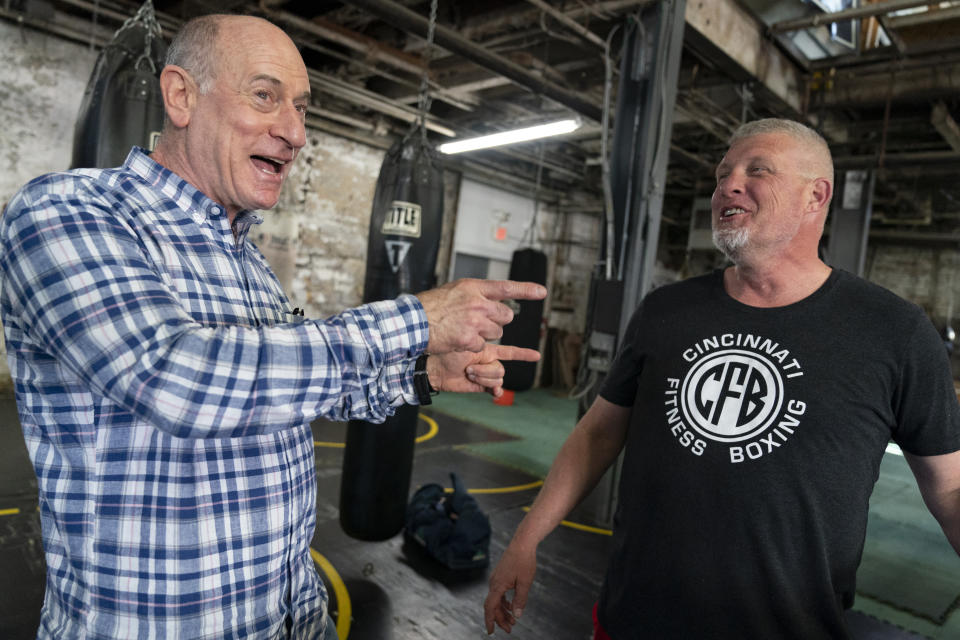 FILE - Ohio Congressional candidate Phil Heimlich, left, speaks with patrons at Cincinnati Fitness & Boxing in Cincinnati, April 23, 2022. (AP Photo/Jeff Dean, File)