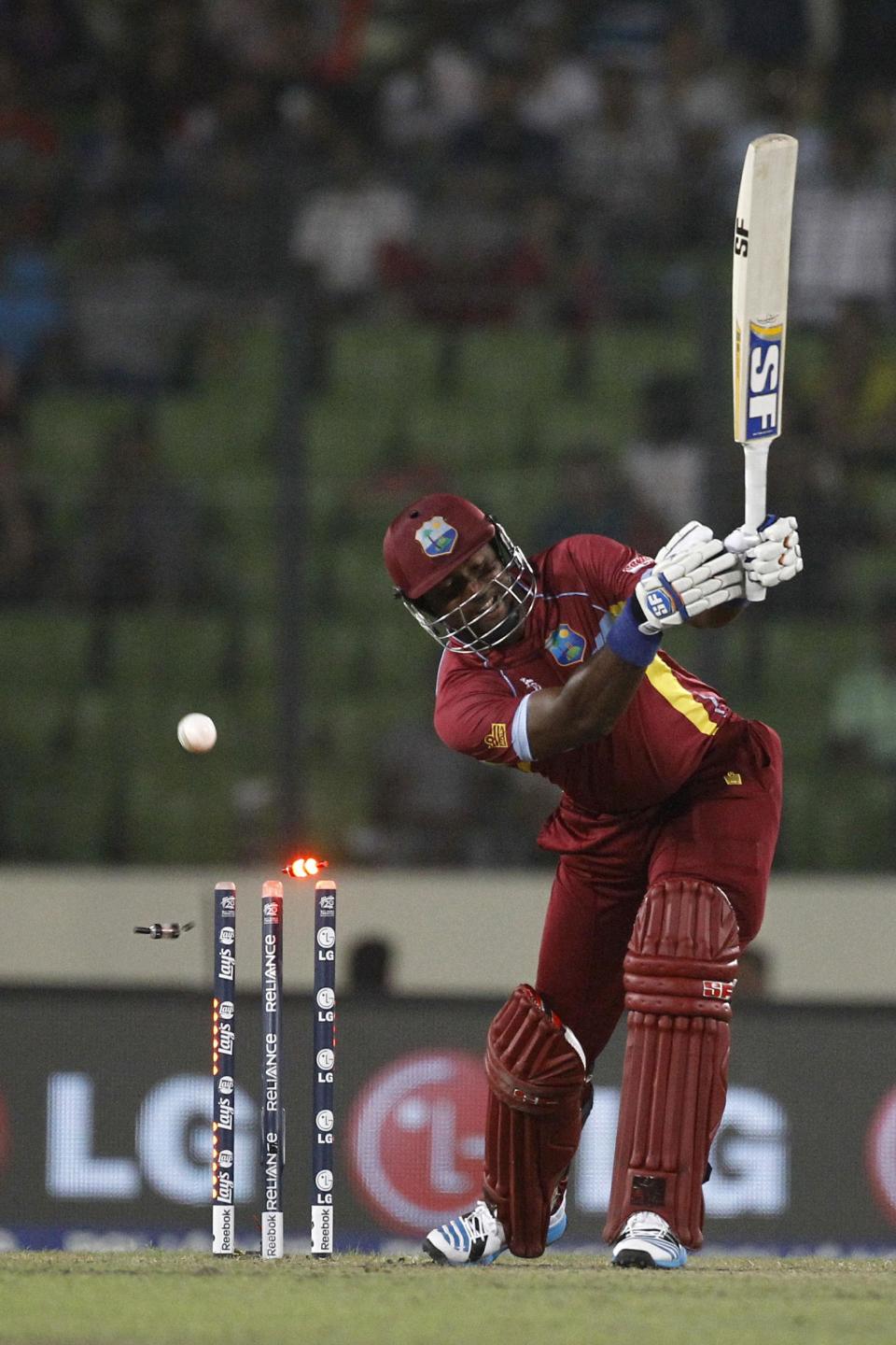 West Indies's Dwayne Smith is bowled out by Sri Lanka's Lasith Malinga during their ICC Twenty20 Cricket World Cup semi-final match in Dhaka, Bangladesh, Thursday, April 3, 2014.(AP Photo/A.M. Ahad)