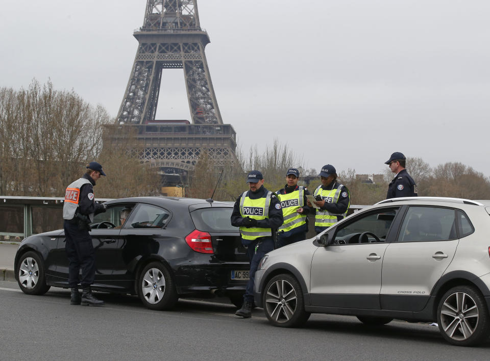 Police officers control vehicles along the Seine river in Paris, Monday, March 17, 2014. Cars with even-numbered license plates are prohibited from driving in Paris and its suburbs Monday, following a government decision over the weekend. Paris is taking drastic measures to combat its worst air pollution in years, banning around half of the city's cars and trucks from its streets in an attempt to reduce the toxic smog that's shrouded the City of Light for more than a week. The Eiffel Tower is seen in the background. (AP Photo/Michel Euler)