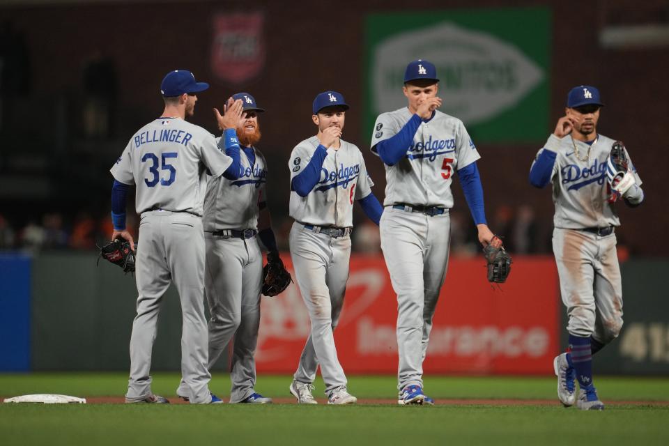 Dodgers first baseman Cody Bellinger (35) celebrates with third baseman Justin Turner (10) and second baseman Trea Turner (6) and shortstop Corey Seager (5) and right fielder Mookie Betts (right).