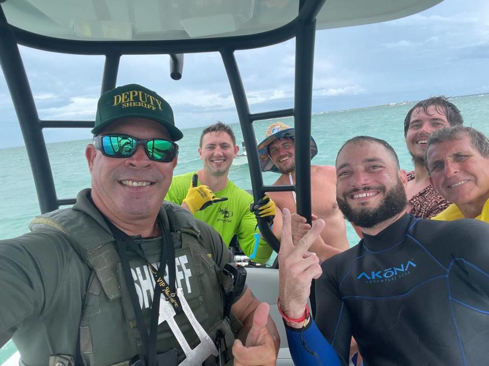 Monroe County Sheriff’s Office Deputy Willie Guerra takes a selfie with five men he just rescued from a sinking boat Thursday, July 27, 2023.