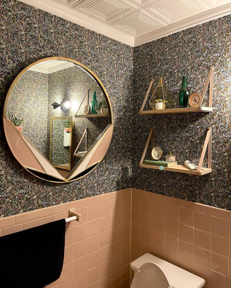 Leather strapped hanging shelves in newly renovated bathroom.