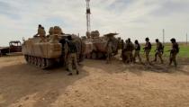 Still image from video shows Syrian rebel fighters near tanks, near Tal Abyad