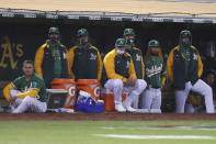 Oakland Athletics watch from the dugout during the sixth inning of the team's baseball game against the Los Angeles Dodgers in Oakland, Calif., Tuesday, April 6, 2021. (AP Photo/Jed Jacobsohn)