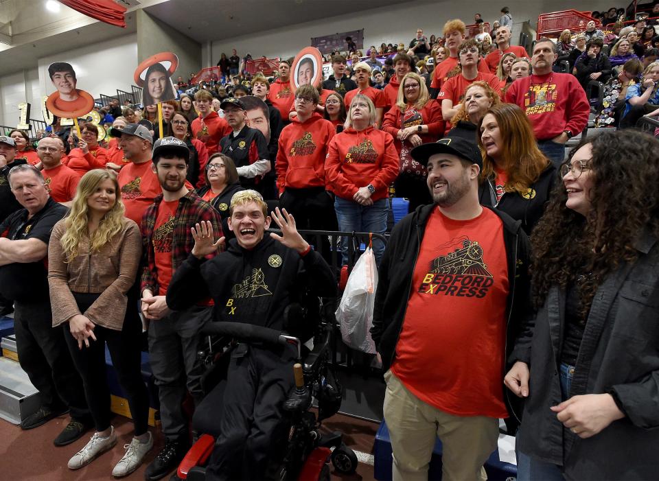 Braden Gandee (center) leads the Bedford Express FRC Team #1023 robotic team members, coaches and mentors chant as one student/mentor yells BX, everyone else yells ON TRACK as they do this three times, then a student/mentor yells LET's GO and everyone else screams. Family members (left) Hunter Gandee, 24, girl friend Sophie Dettling and (right) Kerragan Gandee, 23, and her fiance is Nate Ash. Behind Kerragan, is their mother Danielle Gandee.